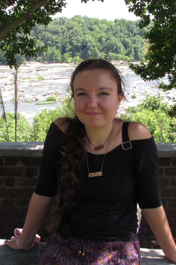 Young lady with river and trees in the background
