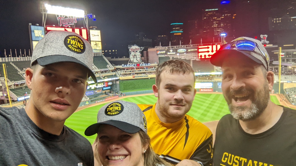 three men and a woman at target field