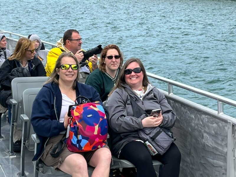 Image of advisors, Gigi, Jess, and Jody on the a boat. 