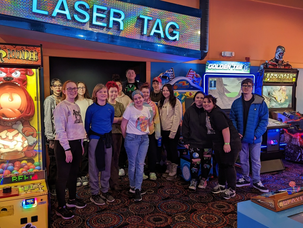 A group of students under a sign that says "Laser Tag"