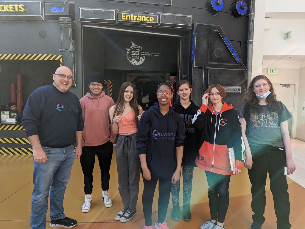 teenagers standing in front of an entrance to 5D Extreme attraction