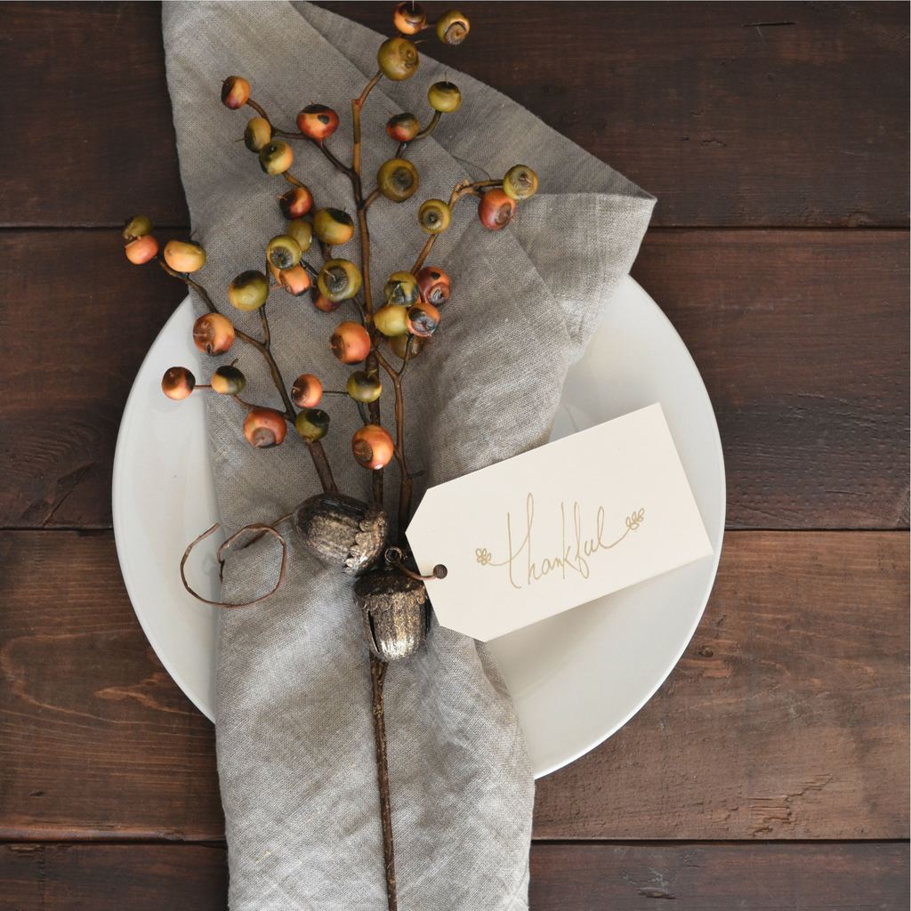 Fall plants wrapped in a napkin with a thankful tag